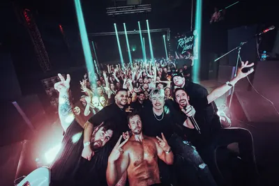 The band in front of a packed room after a show