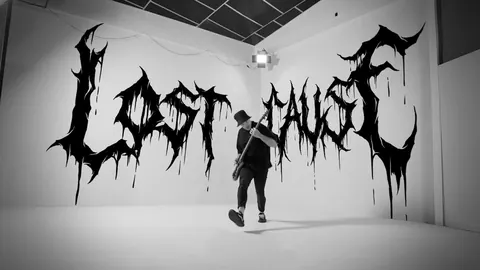 Lost Cause video thumbnail: the bassist playing in a white room, Lost Cause lettered in dripping black across the walls